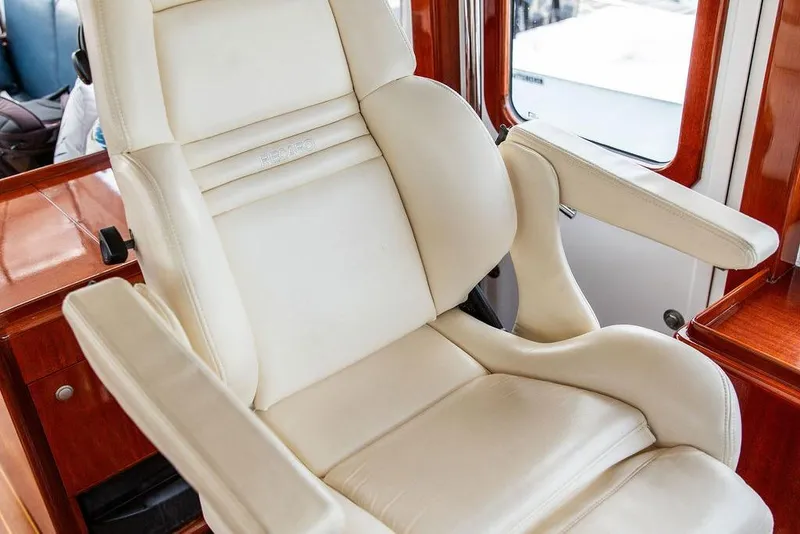Slide: The Image of Luxurious white leather captain's chair on 2008 Huckins Linwood yacht interior. - 23