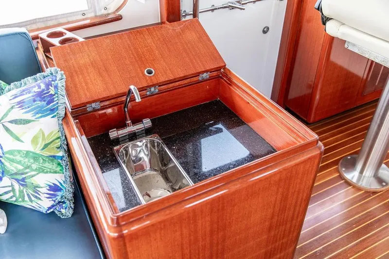 Slide: The Image of Luxurious 2008 Huckins Linwood yacht interior with wooden cabinetry and built-in sink. - 24