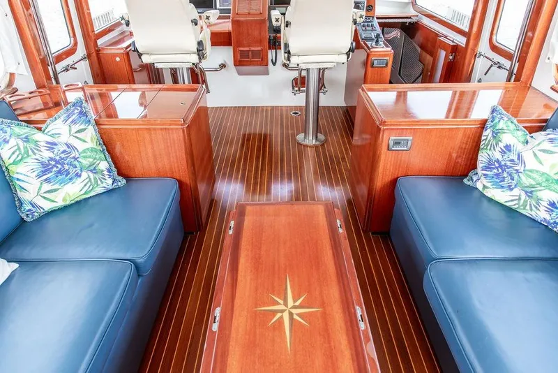 Slide: The Image of Luxurious 2008 Huckins Linwood yacht interior with blue seating and elegant wood finishes. - 25
