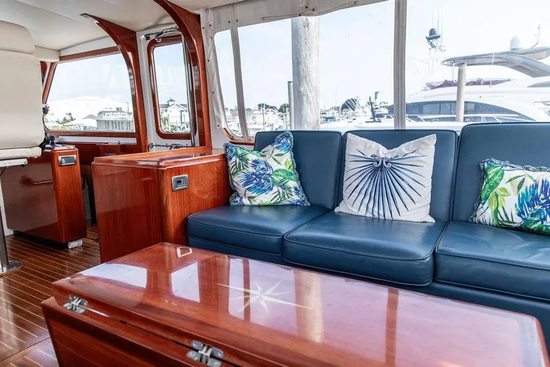 Slide: The Image of Luxurious 2008 Huckins Linwood yacht interior with blue leather seating and tropical-themed cushions. - 26