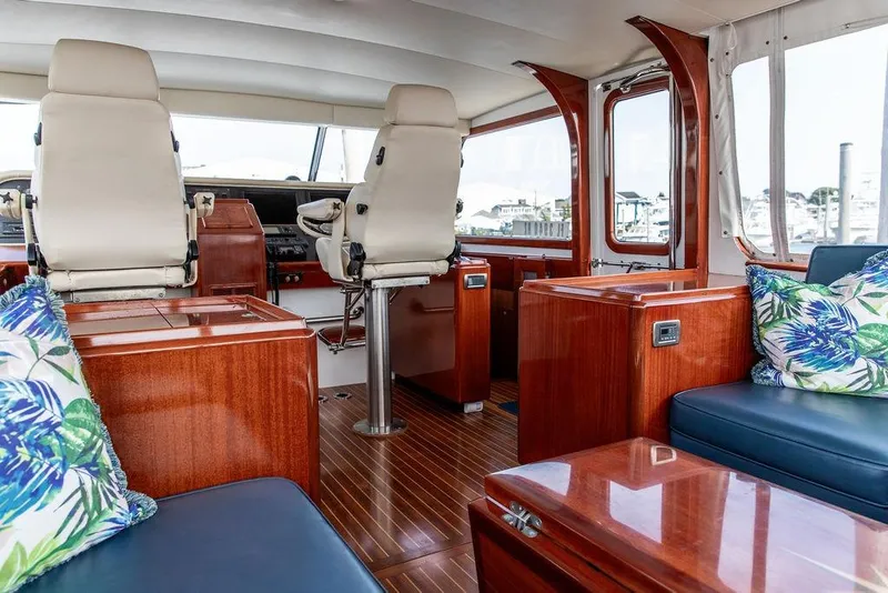 Slide: The Image of Luxurious 2008 Huckins Linwood yacht interior with plush seating and elegant wood finishes. - 27