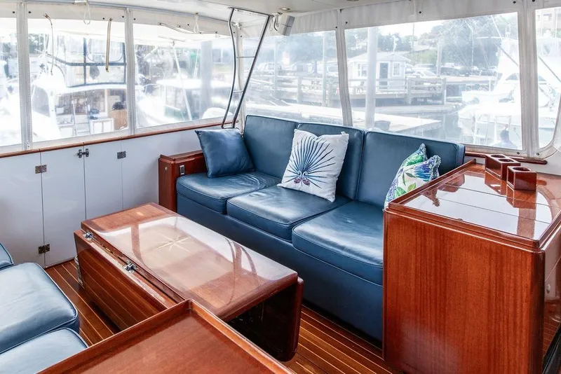 Slide: The Image of Luxurious 2008 Huckins Linwood yacht interior with blue seating and wooden accents. - 28