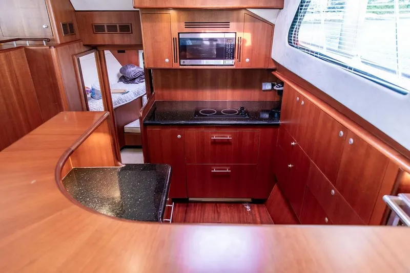 Slide: The Image of Luxurious 2008 Huckins Linwood yacht kitchen with wood cabinetry and modern appliances. - 36