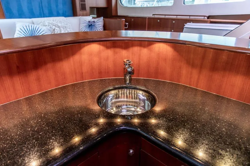 Slide: The Image of Luxurious 2008 Huckins Linwood yacht interior with elegant sink and polished wood finish. - 37