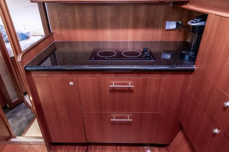 Slide: The Image of 2008 Huckins Linwood yacht kitchen with sleek wood cabinetry and modern appliances. - 38