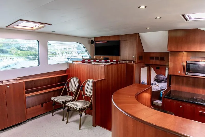 Slide: The Image of Luxurious 2008 Huckins Linwood yacht interior with wood paneling, seating, and modern amenities. - 40