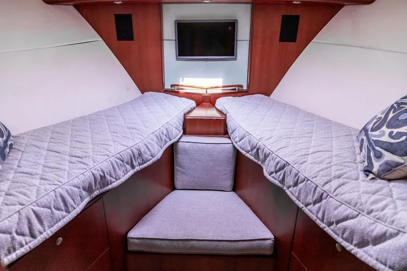 Slide: The Image of Interior of 2008 Huckins Linwood yacht with twin beds and a small TV. - 5