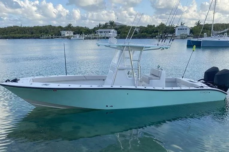 The Image of 2019 Conch 30 boat on trailer under clear blue sky. - 1