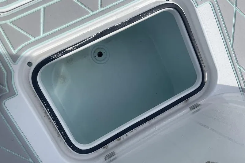 Slide: The Image of Open storage compartment on 2019 Conch 30 boat with speakers and non-slip flooring. - 12