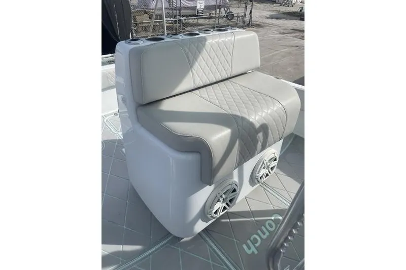 Slide: The Image of Interior view of a 2019 Conch 30 boat with speakers and storage compartment. - 17