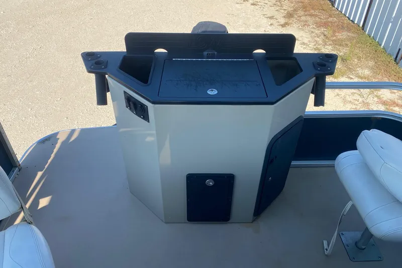 Slide: The Image of 2014 Lowe SF214 Sport Fish boat console with seating and storage compartments. - 11