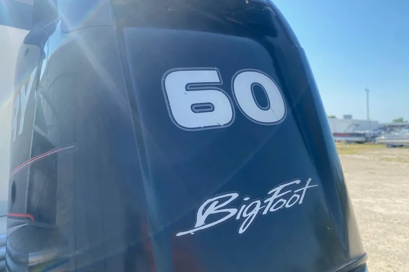 Slide: The Image of Outboard motor with "60 BigFoot" branding on a 2014 Lowe SF214 Sport Fish boat. - 4