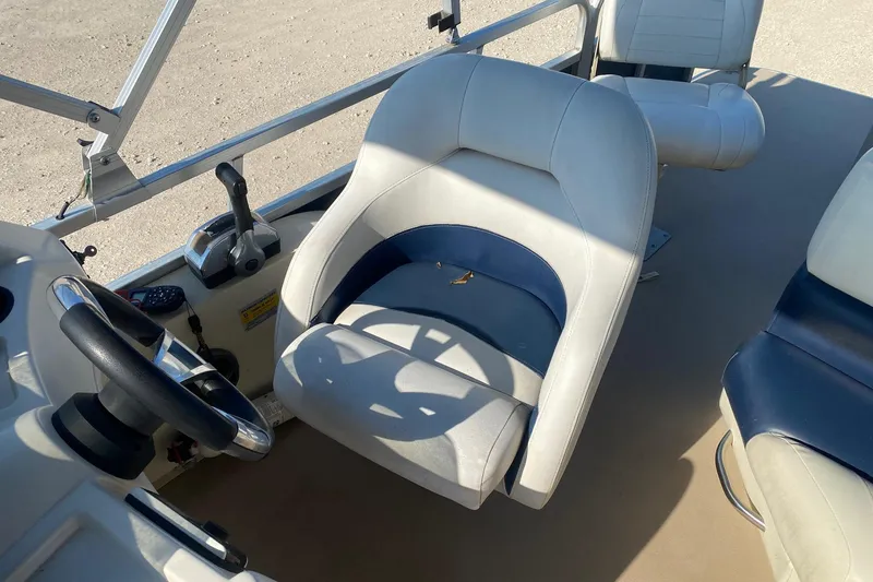 Slide: The Image of 2014 Lowe SF214 Sport Fish boat interior with steering wheel and seating. - 8