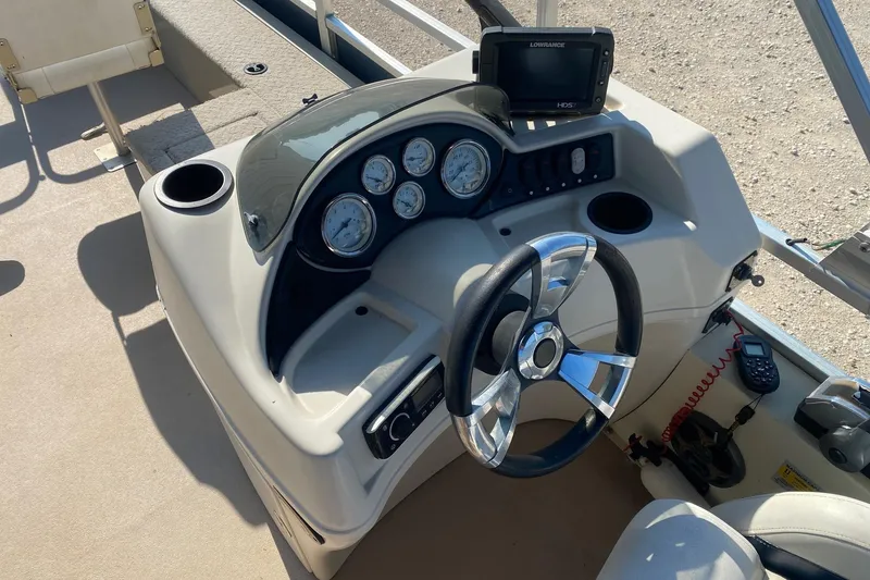 Slide: The Image of 2014 Lowe SF214 Sport Fish boat dashboard with steering wheel and gauges. - 9