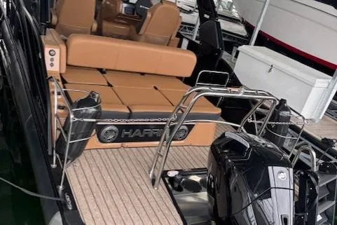 Slide: The Image of 2025 Harris Grand Mariner 230 boat interior with tan seating and modern outboard motor. - 3