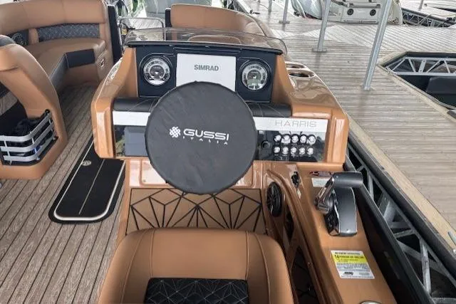 Slide: The Image of 2025 Harris Grand Mariner 230 boat dashboard with Gussi steering wheel and Simrad display. - 5