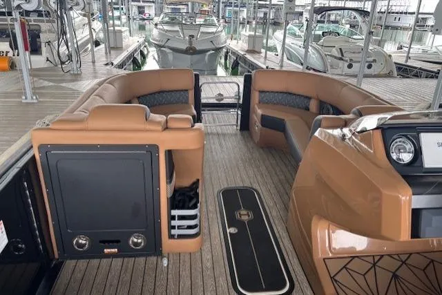 Slide: The Image of 2025 Harris Grand Mariner 230 interior with luxurious seating and modern design in a marina setting. - 6