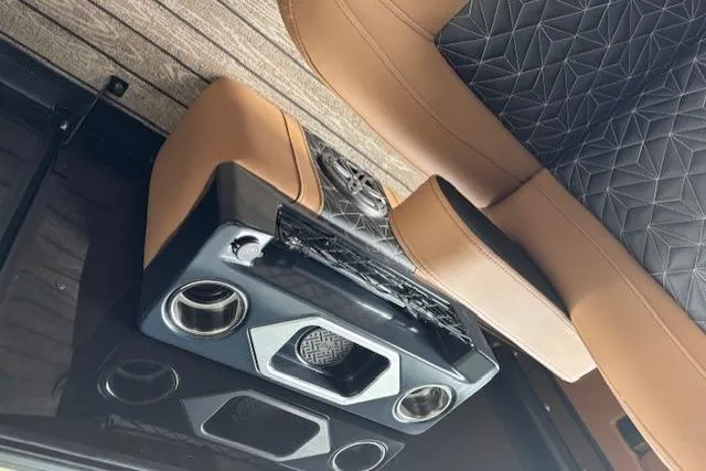 Slide: The Image of 2025 Harris Grand Mariner 230 interior with luxurious seating and modern audio system. - 8