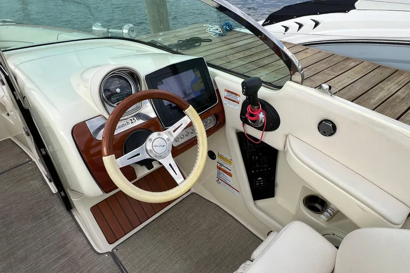 Slide: The Image of 2021 Chris-Craft Launch 25 GT boat dashboard with steering wheel and navigation display. - 16