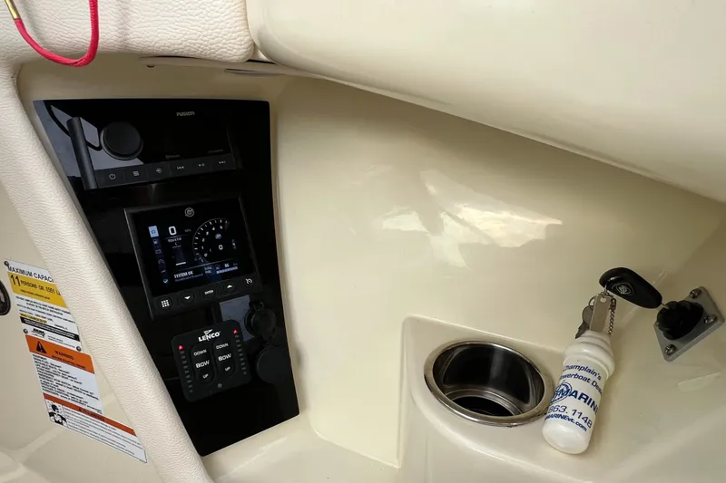 Slide: The Image of 2021 Chris-Craft Launch 25 GT dashboard with controls and key fob. - 17