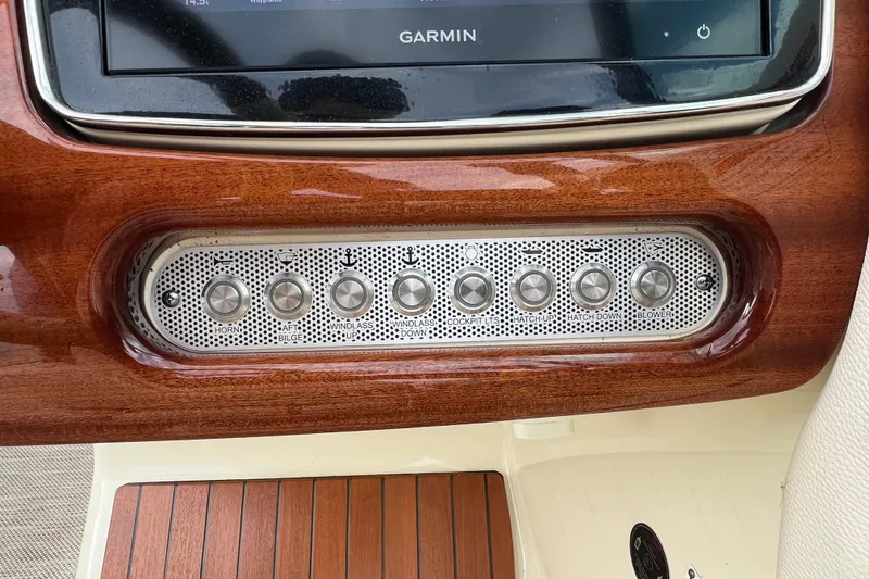 Slide: The Image of 2021 Chris-Craft Launch 25 GT dashboard with Garmin display and control buttons. - 20