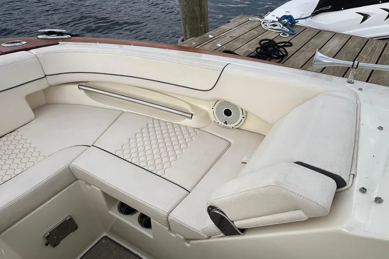 Slide: The Image of 2021 Chris-Craft Launch 25 GT boat interior with white seating and speaker detail. - 24