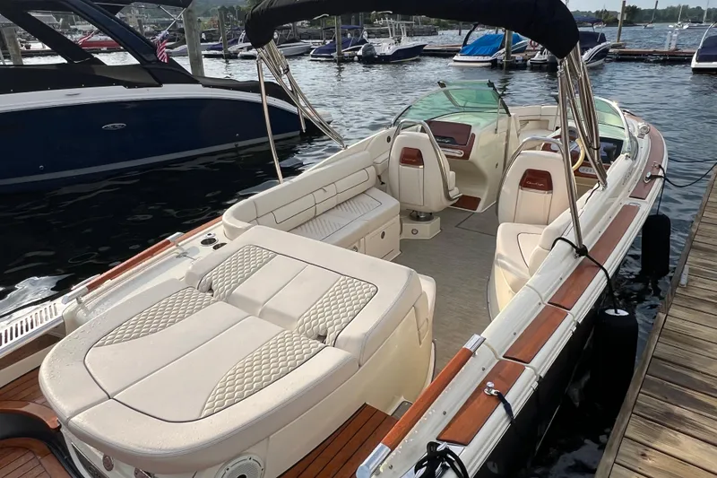 Slide: The Image of 2021 Chris-Craft Launch 25 GT boat docked, featuring luxurious seating and elegant design. - 3