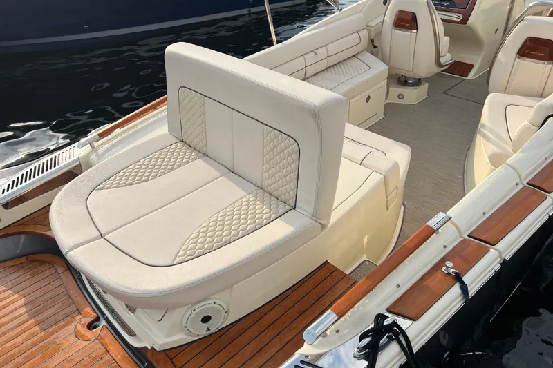 Slide: The Image of 2021 Chris-Craft Launch 25 GT boat interior with luxurious seating and wood accents. - 5