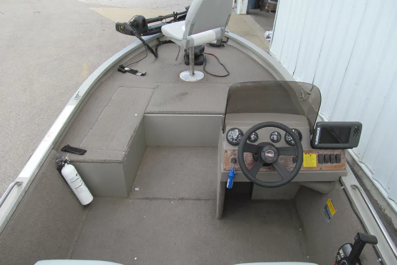 Slide: The Image of 1998 Tracker boat interior with steering wheel, control panel, and seating area. - 5