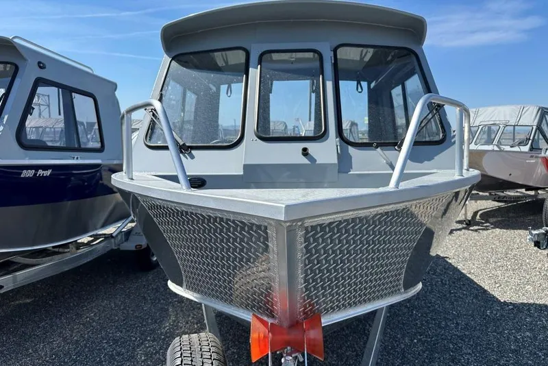 Slide: The Image of 2025 Hewescraft 200 ProV ET HT boat, front view, parked on gravel lot. - 3