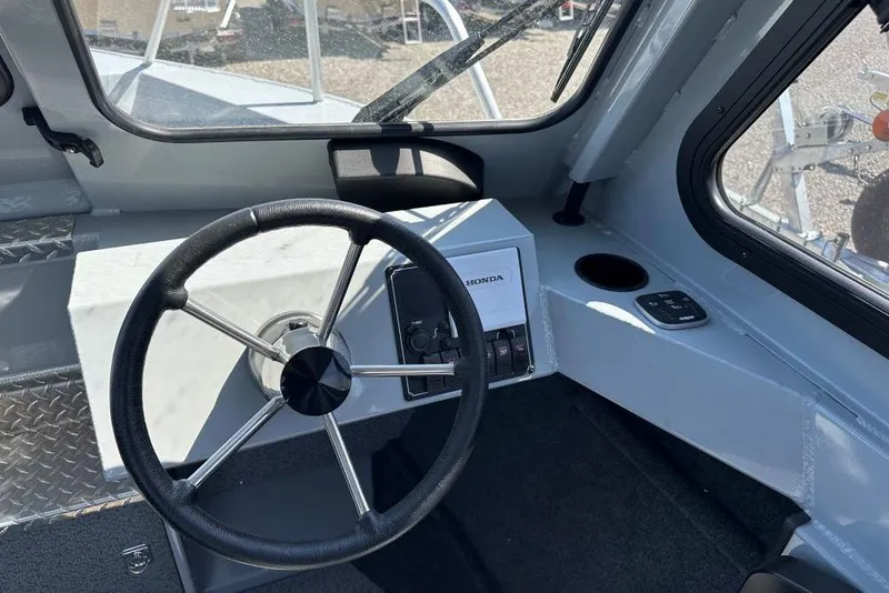 Slide: The Image of Steering wheel and dashboard of 2025 Hewescraft 200 ProV ET HT boat. - 7