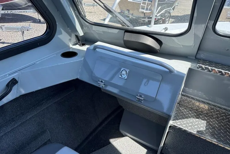 Slide: The Image of 2025 Hewescraft 200 ProV ET HT interior with storage compartment and cup holder. - 8