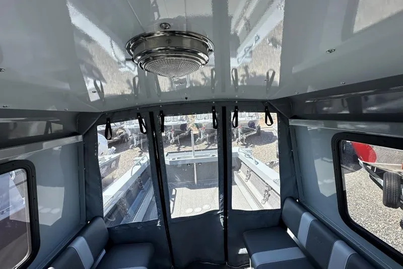 Slide: The Image of Interior of 2025 Hewescraft 200 ProV ET HT boat, featuring seating and windows. - 9