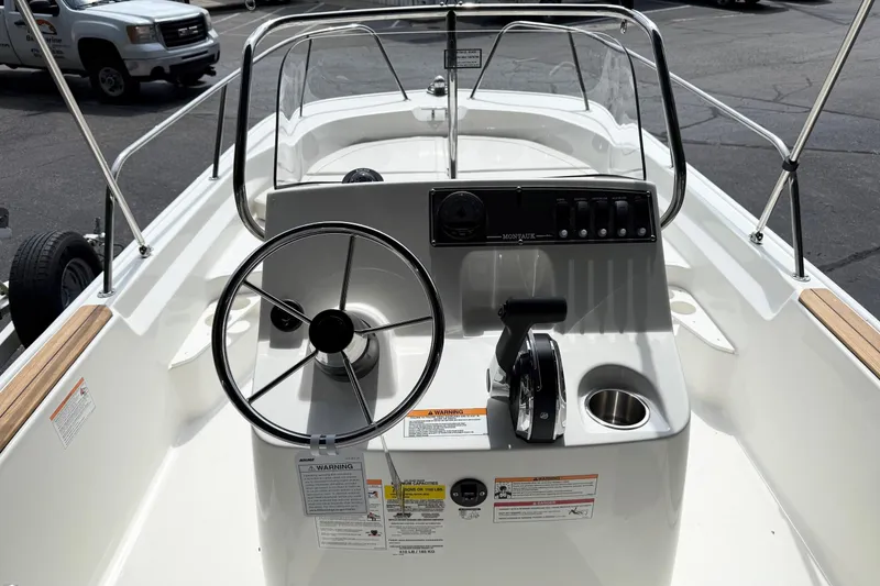 Slide: The Image of 2026 Boston Whaler 170 Montauk boat console with steering wheel and controls. - 4