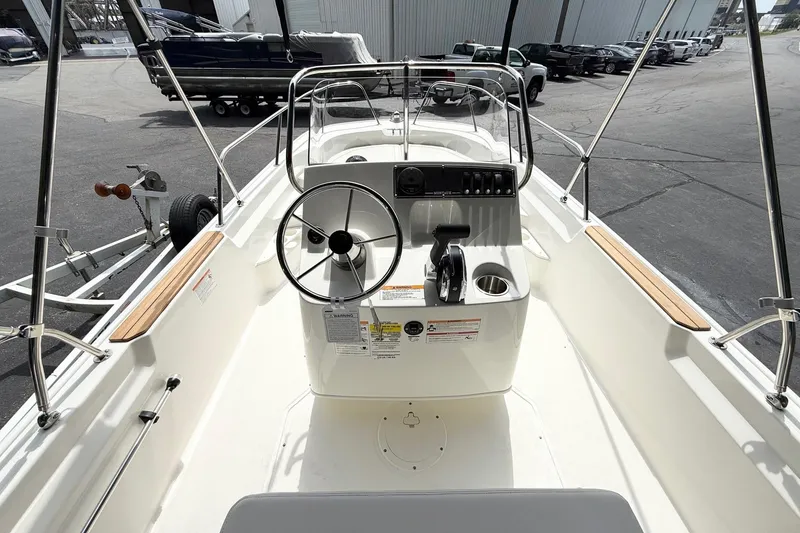 Slide: The Image of 2026 Boston Whaler 170 Montauk boat interior with steering wheel and control panel. - 5