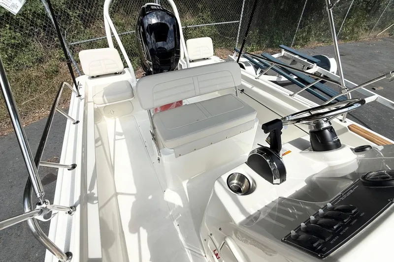 Slide: The Image of 2026 Boston Whaler 170 Montauk boat interior with steering console and seating. - 6