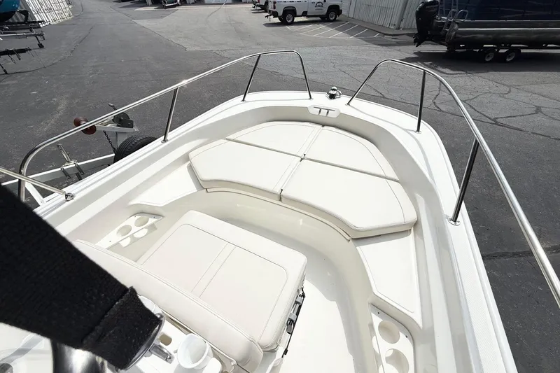 Slide: The Image of 2026 Boston Whaler 170 Montauk boat interior with cushioned seating and cup holders. - 7