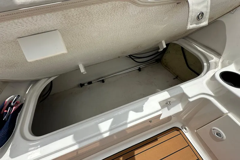 Slide: The Image of 2021 Bayliner Element E18 boat storage compartment with open hatch and visible interior space. - 12