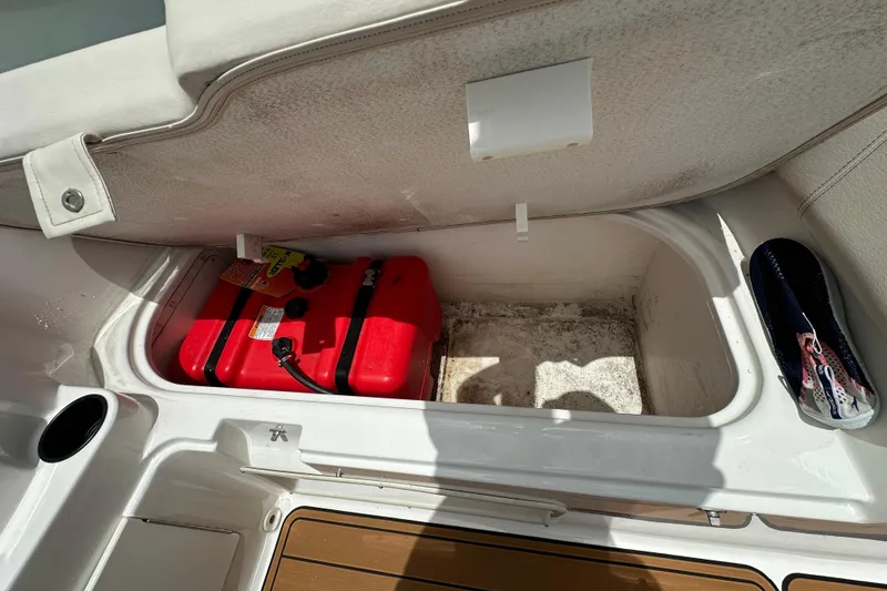 Slide: The Image of 2021 Bayliner Element E18 boat storage compartment with red fuel tank. - 13