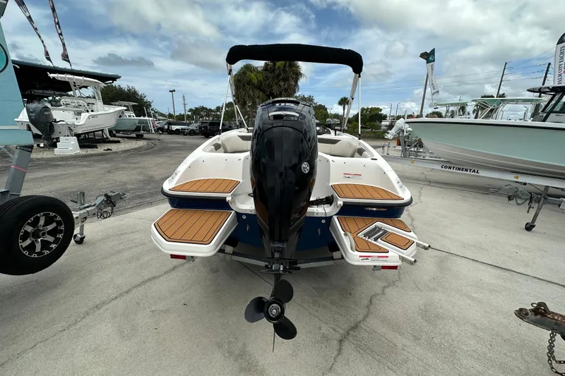 Slide: The Image of 2021 Bayliner Element E18 boat with outboard motor, displayed at a marina. - 3