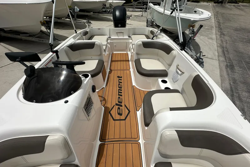 Slide: The Image of 2021 Bayliner Element E18 boat interior with seating and steering console. - 9