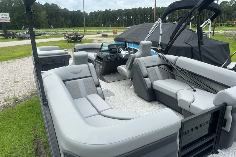 Slide: The Image of 2025 Bennington 24M pontoon boat interior with plush seating and modern dashboard. - 4