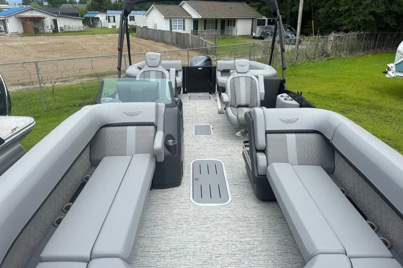 Slide: The Image of 2025 Bennington 24M pontoon boat with luxurious gray seating and spacious deck layout. - 5