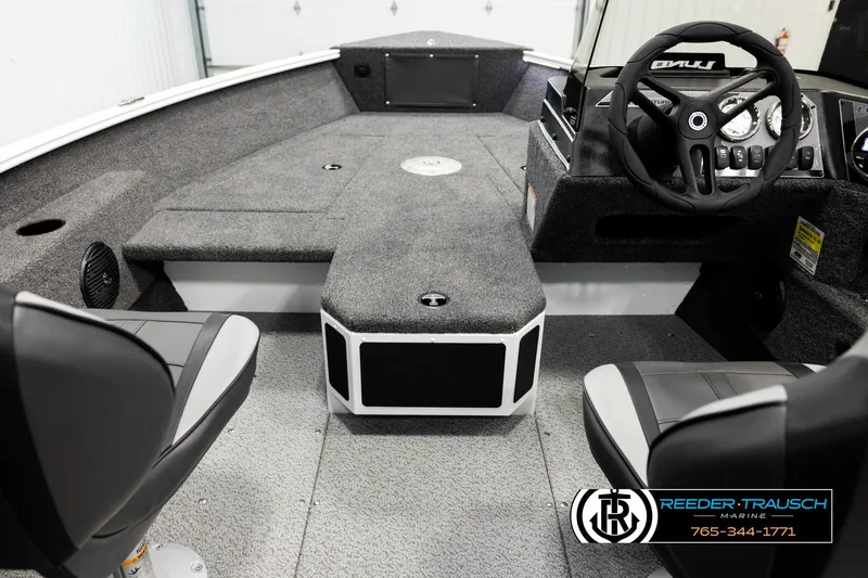 Slide: The Image of 2026 Lund 1775 Adventure SS boat interior with steering wheel and seating. - 12