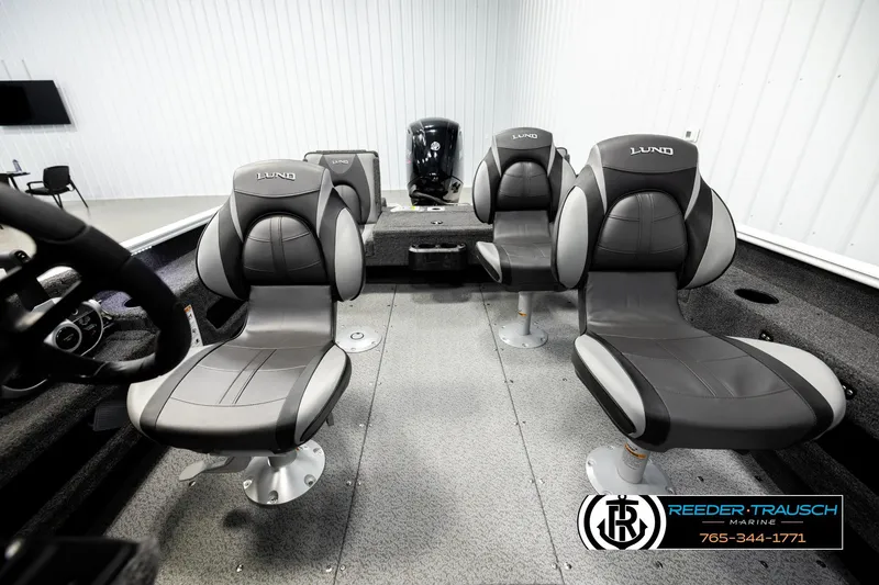 Slide: The Image of 2026 Lund 1775 Adventure SS boat interior with four cushioned seats in a showroom. - 16