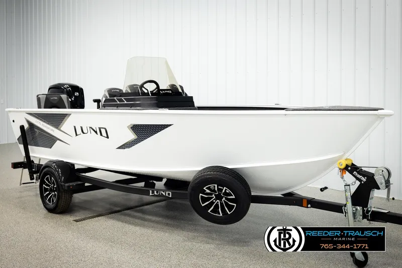 Slide: The Image of 2026 Lund 1775 Adventure SS boat on trailer, displayed indoors, side view. - 2