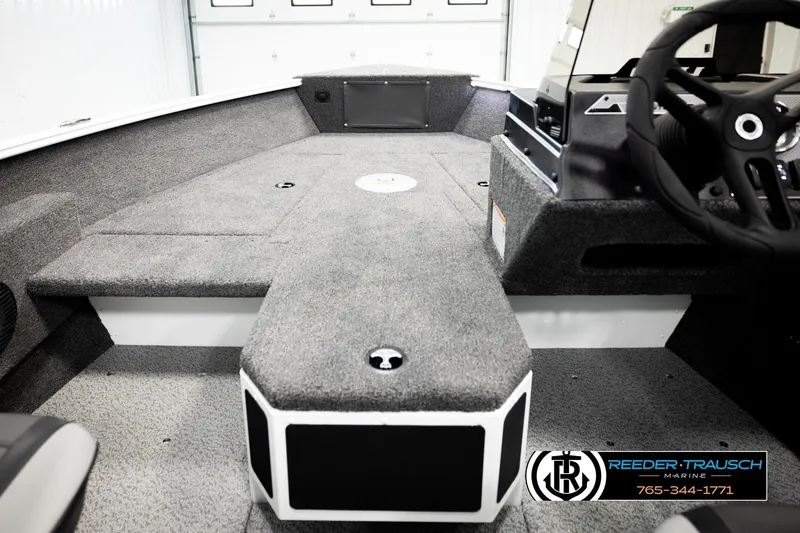 Slide: The Image of 2026 Lund 1775 Adventure SS boat interior with carpeted deck and steering console. - 22