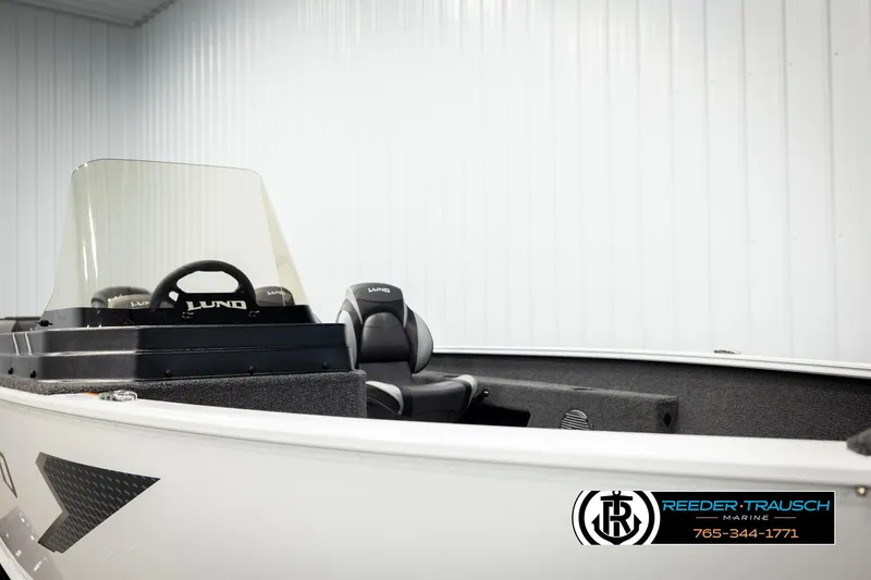 Slide: The Image of 2026 Lund 1775 Adventure SS boat interior with steering wheel and seating. - 24