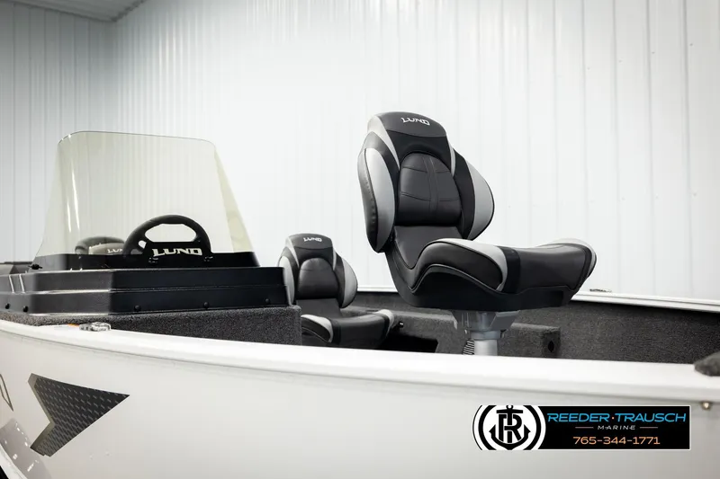 Slide: The Image of 2026 Lund 1775 Adventure SS boat interior with sleek seating and steering console. - 25
