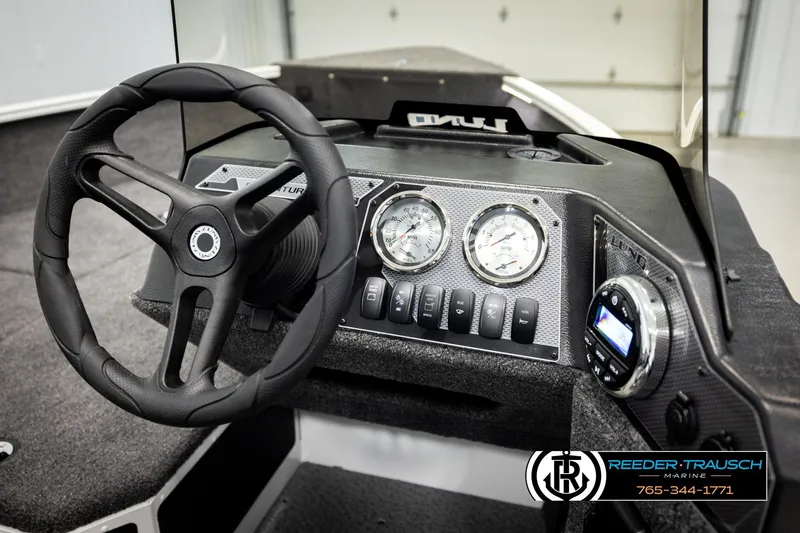 Slide: The Image of 2026 Lund 1775 Adventure SS dashboard with steering wheel and gauges in a showroom. - 26
